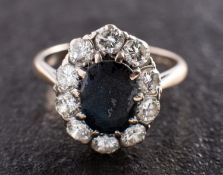 An 18ct gold, mixed-cut oval sapphire and round, brilliant-cut diamond cluster ring,