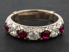A ruby and round, brilliant-cut diamond half-eternity ring, total estimated diamond weight ca. 0.
