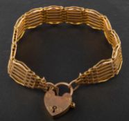 A gate-link bracelet with heart-shaped clasp, stamped '9CT', total length ca. 20.