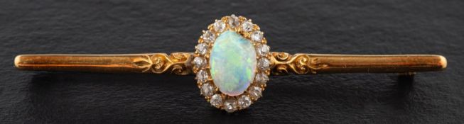An oval cabochon-cut opal and old-cut diamond cluster bar brooch, estimated opal weight ca. 0.