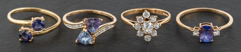 Four 9ct gold gemset rings, including a tanzanite cross-over ring, an amethyst cross-over ring,