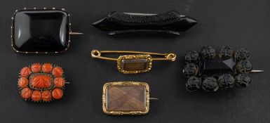 A collection of six brooches,