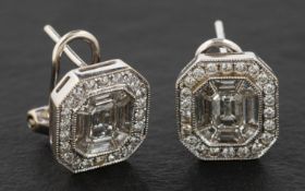 A pair of round, brilliant, calibre and octagonal, step-cut, diamond cluster ear studs,