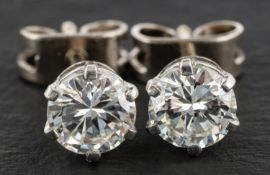 A pair of round, brilliant-cut diamond ear studs, total estimated diamond weight ca. 0.