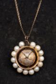 A rotating, globe pendant, with textured raised continents and cultured pearl surround,