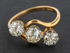 An old-cut diamond, three-stone, cross-over ring, total estimated diamond weight ca.