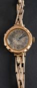 An early 20th century dress wristwatch, the silvered enamel dial with black Arabic numerals,