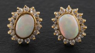 A pair of cabochon-cut opal and CZ cluster ear studs, total estimated opal weight ca. 1.