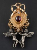 A heart-shaped brooch/ pendant, set with a circular, cabochon-cut garnet and a rose-cut diamond,