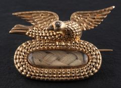 A Georgian memorial brooch with hairwork, surmounted by a dove,