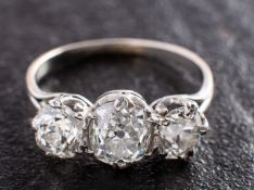 A cushion-cut diamond, three-stone ring, total estimated diamond weight ca. 2.