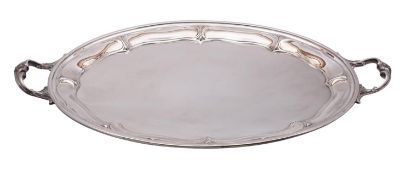 A large silver plated serving tray of oval outline with lobed border and foliate decorated loop