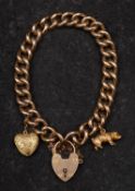 A curb link charm bracelet with heart-shaped clasp, the clasp stamped '9CT',