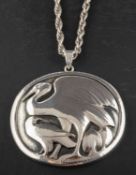 George Jensen (1866-1935) for Georg Jensen, a silver pendant depicting a crane and a raven,