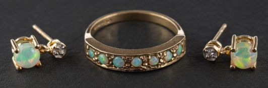 A 9ct gold, cabochon-cut opal, half-eternity ring, length of ring head ca. 1.