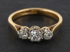 A round, brilliant-cut diamond three-stone ring, total estimated diamond weight ca. 0.