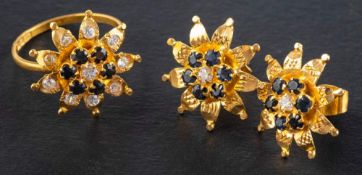 A pair of sapphire and white paste ear studs and ring, of stylised flowerhead design,