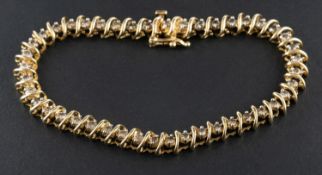 An 'S'-link, round brilliant-cut diamond, tennis bracelet, total estimated diamond weight ca. 1.