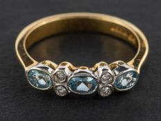 An 18ct gold, oval, mixed-cut aquamarine and round, brilliant-cut diamond ring,
