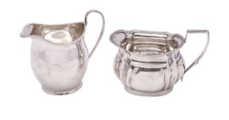 An Edward VII silver cream jug, maker Thomas Hayes, Birmingham, 1904 of barge-shaped outline,