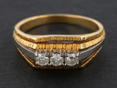 A round, brilliant-cut diamond, three-stone ring, total diamond weight 0.