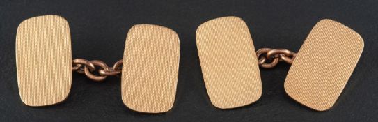 A pair of 9ct gold, rectangular cufflinks with engine-turned decoration,