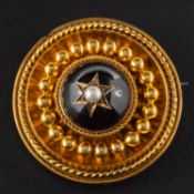 A Victorian Etruscan revival, cabochon-cut garnet and seed pearl locket brooch/ pendant,