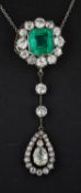 An octagonal step cut emerald and old-cut diamond cluster with pear-shaped diamond drop pendant