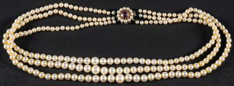 A three-row, graduated, cultured pearl necklace, the pearls of yellowish hue with pink overtones,