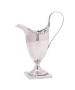A George III silver cream jug, maker Hester Bateman, London, 1809, of helmet shaped outline,