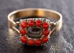 An early 19th century sentimental ring, the hairwork centrepiece with beaded coral surround,