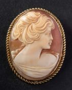 A shell cameo brooch, depicting a lady in profile, to rope twist surround, length ca. 4.