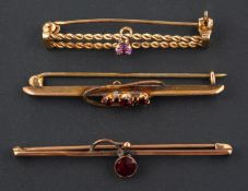 Three bar brooches, including a 9ct gold amethyst brooch; a three-stone garnet brooch,