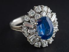 An oval, mixed-cut sapphire, baguette and round, brilliant-cut diamond dress ring,