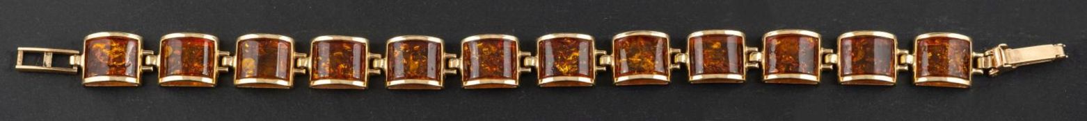 A 9ct gold amber bracelet, the amber comprising semi-cylindrical links, with hallmarks for London,