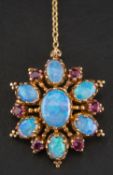 A 9ct gold, oval, cabochon-cut opal and mixed-cut ruby pendant/ brooch,