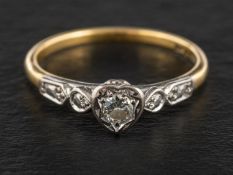 A round, brilliant-cut diamond single-stone ring, the diamond within a heart-shaped mount,