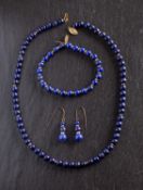 A lapis lazuli bead necklace, bracelet and pair of drop earrings,