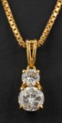 A round, brilliant-cut diamond two-stone pendant, weight of principal diamond ca. 0.
