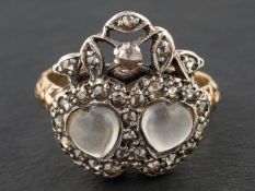 A 19th century, 'Luckenbooth' ring, depicting two cabochon-cut moonstone hearts entwined,