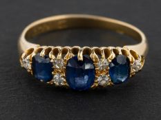 A cushion-cut sapphire, three-stone ring, with single-cut diamond spacers,