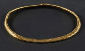 A flexible 'gas pipe' link tubular necklace, stamped 'K18', with import marks for London, 1989,