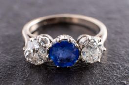 A sapphire and cushion-cut diamond, three-stone ring, total estimated sapphire weight ca. 1.