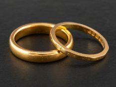 Two 22ct gold band rings, including one with engraved floral decoration,