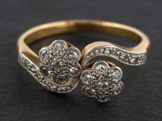 A single-cut diamond, double-flowerhead ring, of cross-over design,