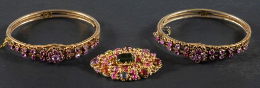 Two Indian, gemset hinged bangles and a brooch, set with vari-coloured,