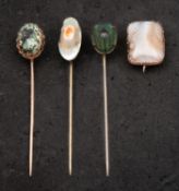 Three tiepins and a brooch, including mother-of-pearl and beetle tiepins, both stamped 'STERLING',