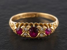 An Edwardian, 18ct gold, mixed-cut ruby three-stone ring, with rose-cut diamond spacers, 0.