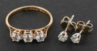 A 9ct gold, synthetic, white spinel, three-stone ring and a pair of round, brilliant-cut ear studs,