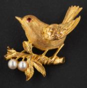 A 9ct gold brooch depicting a song bird on a branch, with cultured pearl berries, diameter ca. 3.
